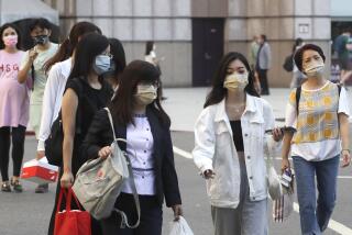FILE - People wear face masks to protect against the spread of the coronavirus in Taipei, Taiwan on Aug. 31, 2022. Taiwan is considering an end to its quarantine requirement for all arrivals in mid-October, the Central Epidemic Command Center said Thursday, Sept. 22, 2022. (AP Photo/Chiang Ying-ying, File)