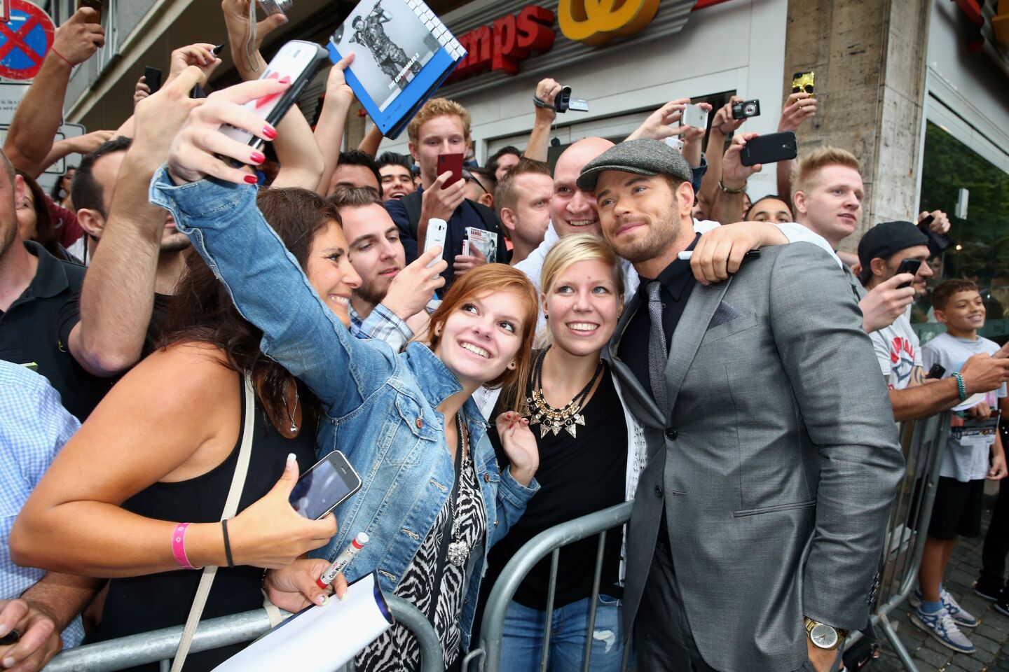 Kellan Lutz gets into the fan shot at the premiere of "The Expendables 3" in Cologne, Germany.