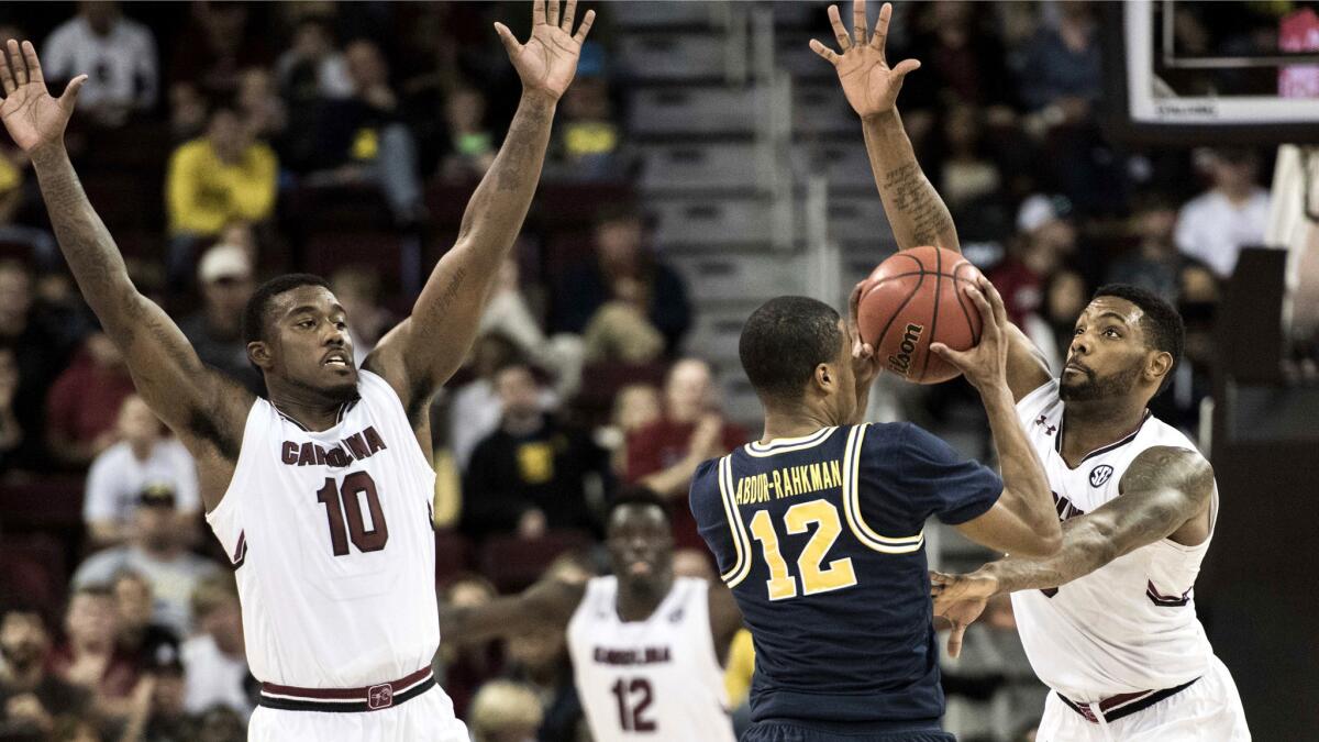 South Carolina guards Duane Notice (10) and Sindarius Thornwell pressure Michigan guard Muhammad-Ali Abdur-Rahkman during the second half of their game Wednesday.