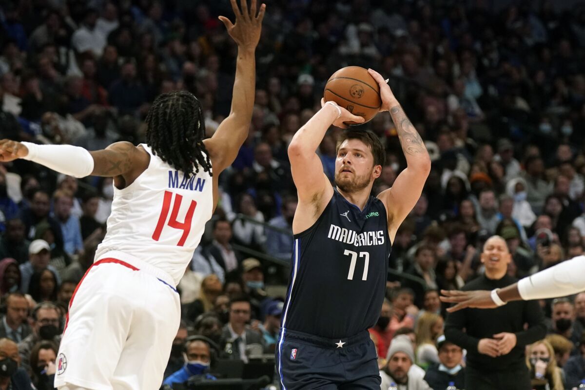 Mavericks guard Luka Doncic pulls up for a shot over Clippers guard Terance Mann.
