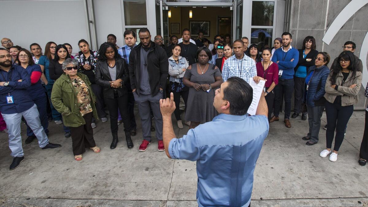 Mario Chavez of St John's Well Child & Family Center briefs workers on how to respond if federal immigration agents visit their clinics. They have practiced linking arms to block entry.