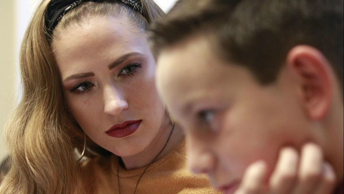 Facilitator Rebeccah Glisson, 25, meets with Nathan Roberts, 10, before a children's grief group session at The Elizabeth Hospice Children's Bereavement Center in Escondido on Oct. 23.