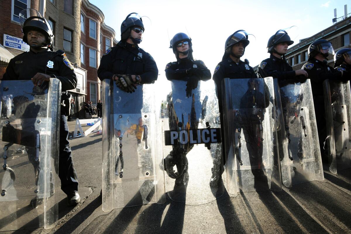 Baltimore police in riot gear block a street after violent protests sparked by the death of Freddie Gray while in police custody last year.