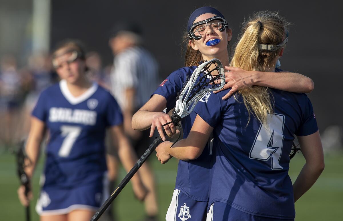 Newport Harbor's Olivia Gritzmacher, left, hugs Joelle Rothbard after she scored a goal on Tuesday.