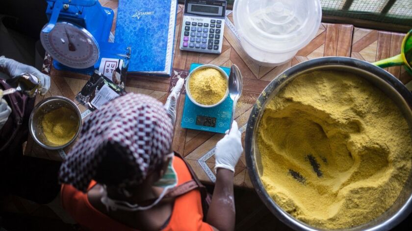 A Liberian woman prepares Power Gari, a fortified cassava porridge made by Just, the company formerly known as Hampton Creek.