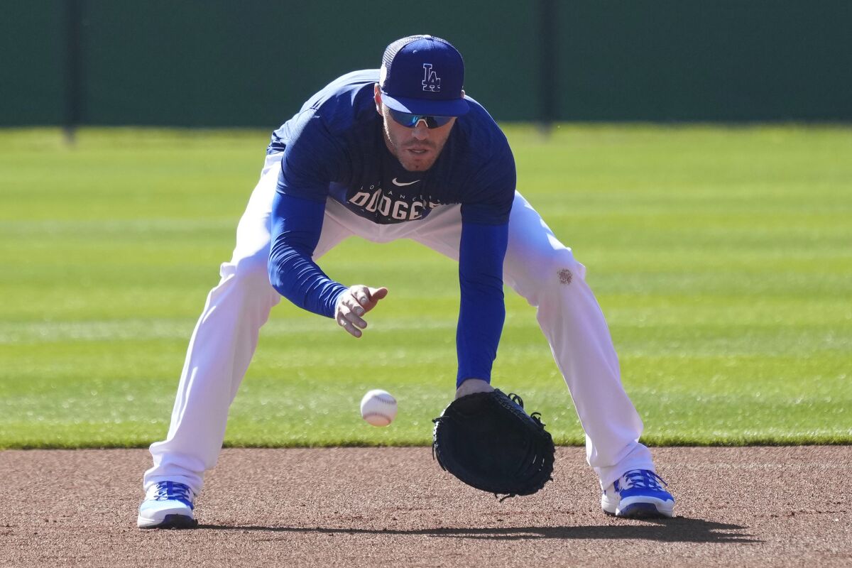 Dodgers first baseman Freddie Freeman fields a ground ball during spring training in Phoenix on Monday.