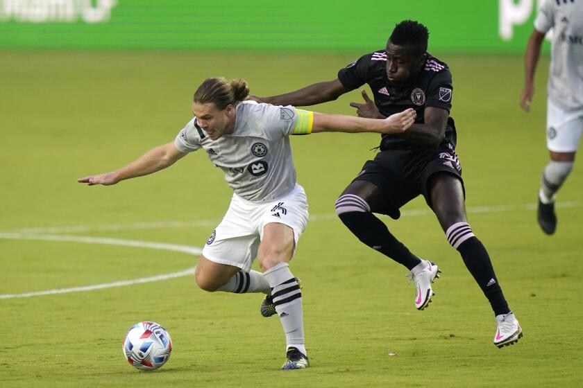 Montreal midfielder Samuel Piette, left, and Inter Miami midfielder Blaise Matuidi, right, go for the ball.