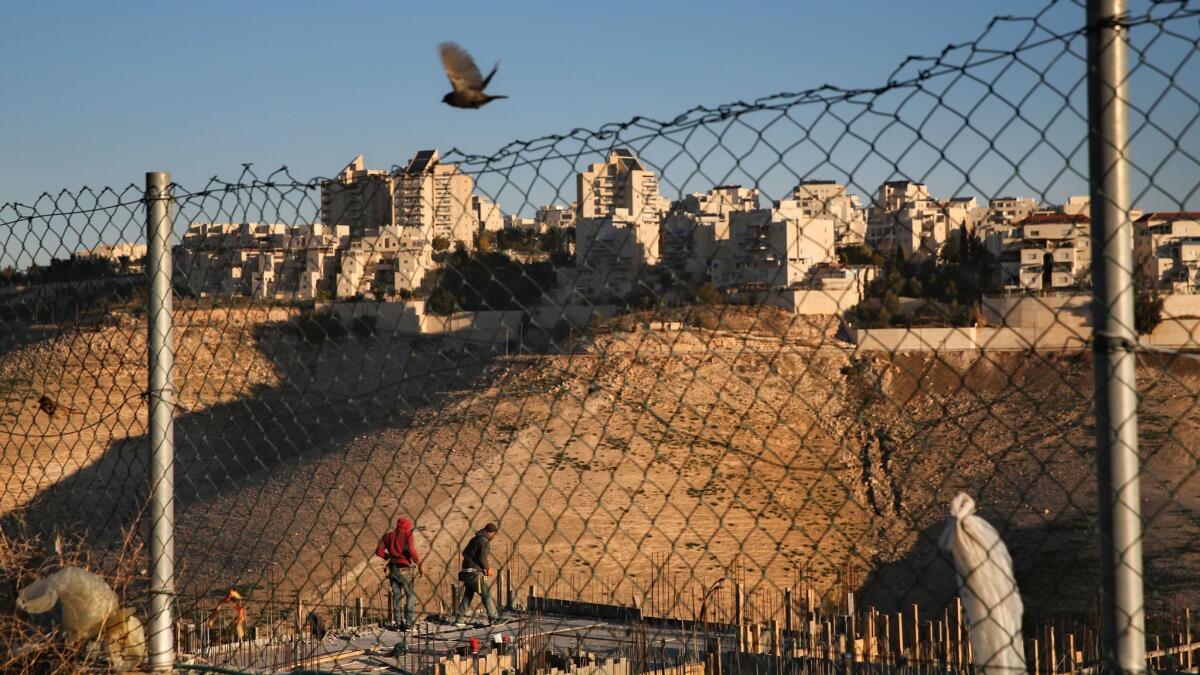 Palestinian laborers work Feb. 7 at a construction site in a new housing project in the Israeli settlement of Maale Adumim, near Jerusalem.