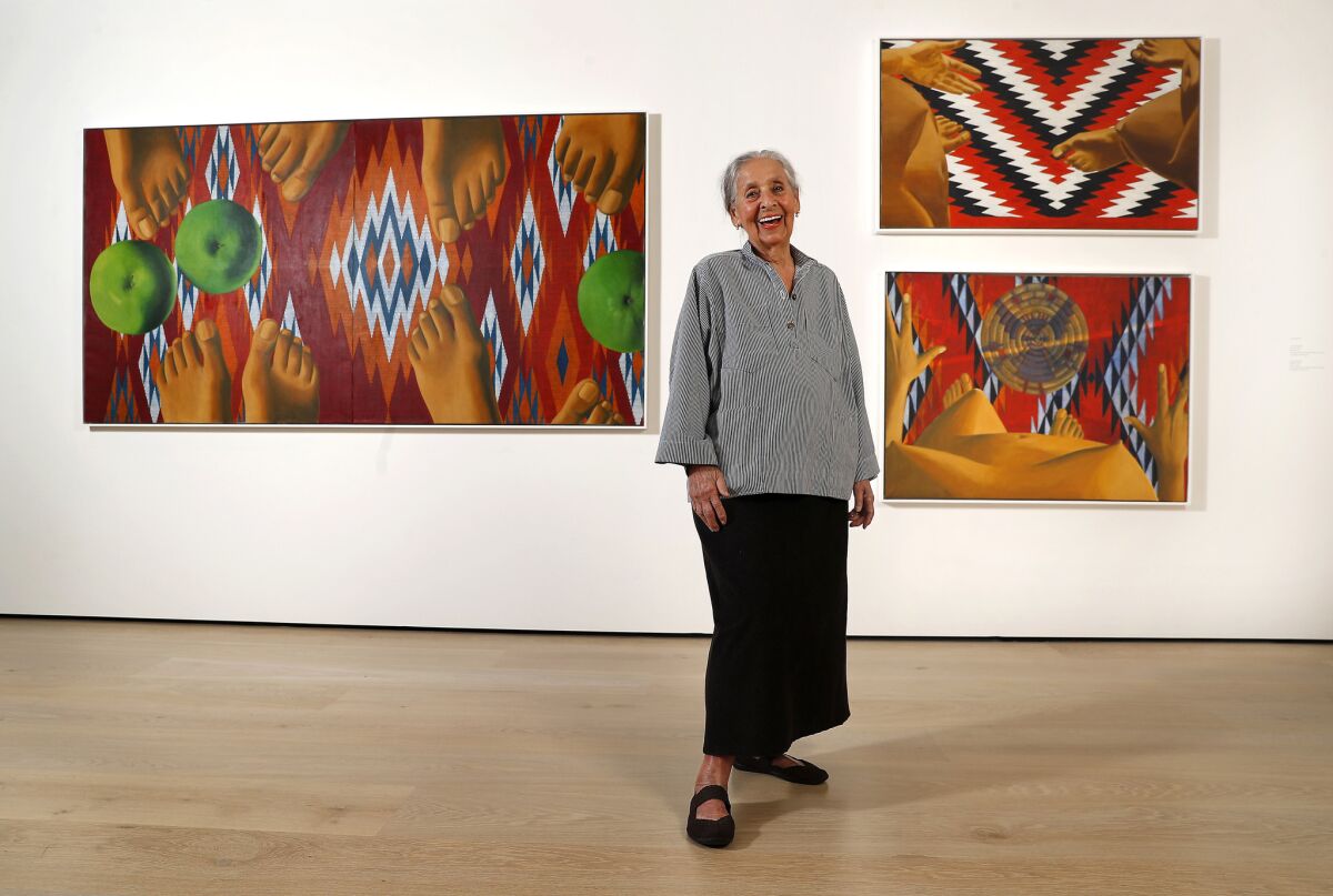 Painter Luchita Hurtado stands before three of her surreal nudes in a gallery at the Hammer Museum in 2018. 