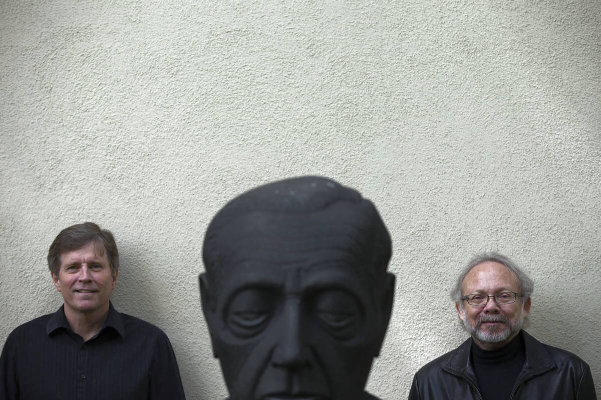 David St. John, right, and Frank Ticheli collaborated on a new piece for the Pacific Chorale at USC. They are photographed behind a statue of Russian cellist Gregor Piatigorsky.
