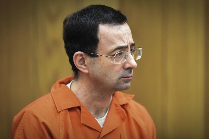 FILE - In this Feb. 5, 2018 file photo, Larry Nassar, former sports doctor who admitted molesting some of the nation's top gymnasts, appears in Eaton County Court in Charlotte, Mich. Numerous people have been criminally charged, fired or forced out of jobs in the wake of the scandal involving once-renowned gymnastics doctor, Nassar, who is serving decades in prison for molesting athletes and for child pornography crimes. (Matthew Dae Smith/Lansing State Journal via AP, File)