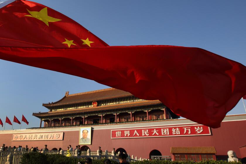 A Chinese national flag flies in front of Tiananmen Gate in Beijing. Experts worry Chinese centers on U.S. campuses may allow China to encourage censorship of certain topics, such as the 1989 Tiananmen Square protests.