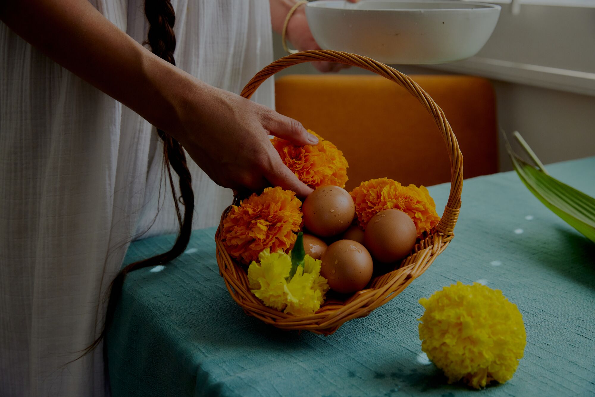Color is a major component of Saehee Cho's tablescapes. A basket of fresh eggs, with vibrant marigolds.