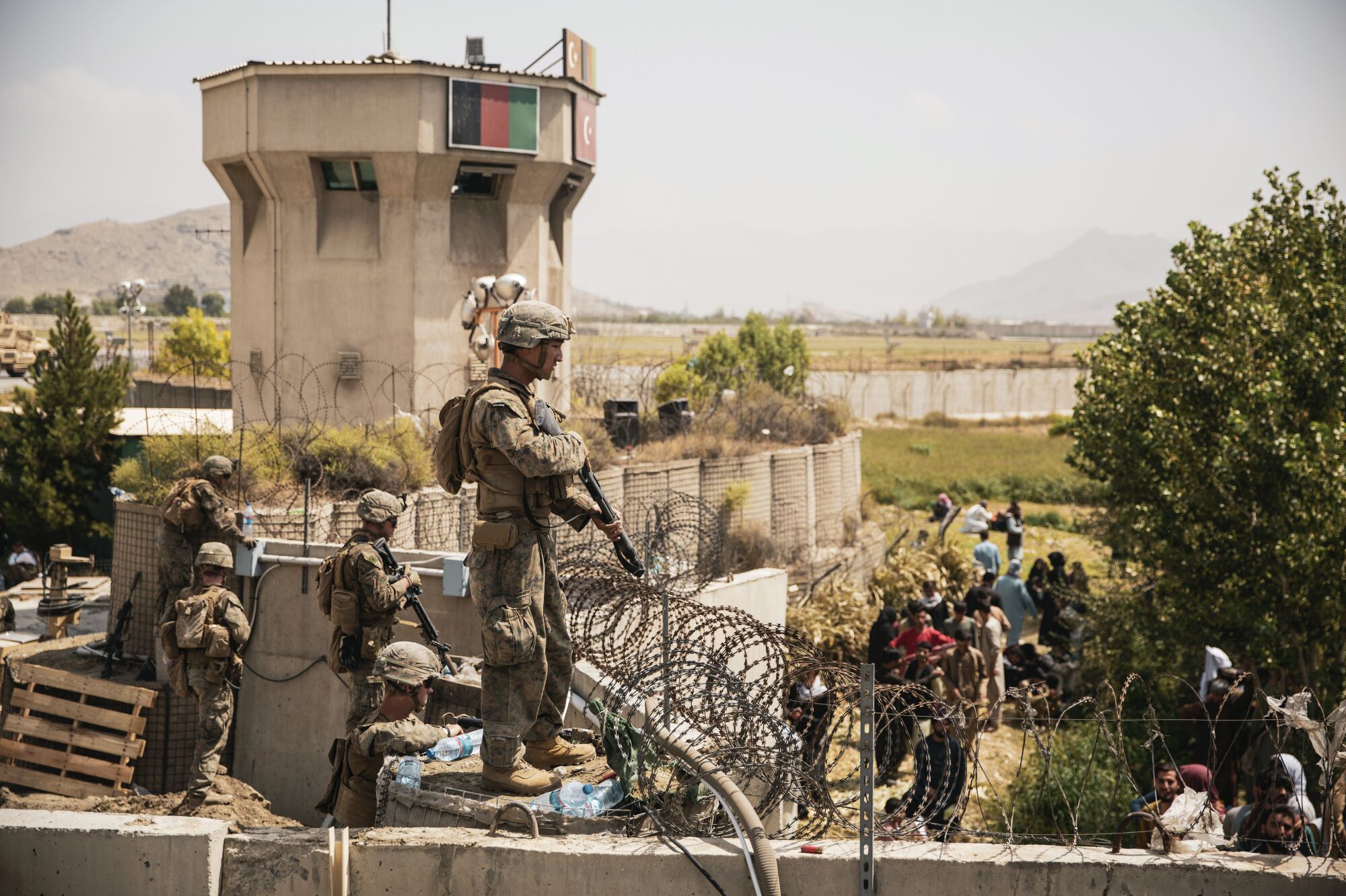 U.S. Marines assist with security at an evacuation control checkpoint