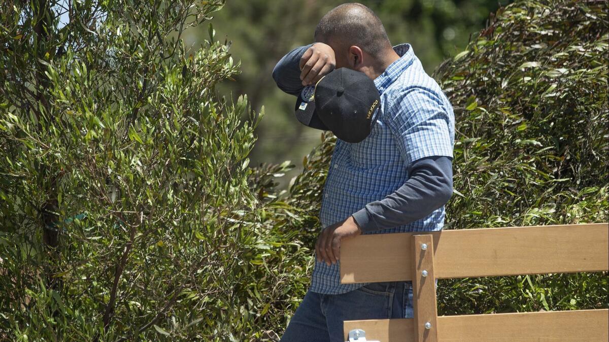 Salvador Betancourt wipes away sweat while unloading trees off a truck at Green Thumb Wholesale Nursery in Canoga Park on July 11. A heat advisory is in effect for part of L.A. County through the weekend.