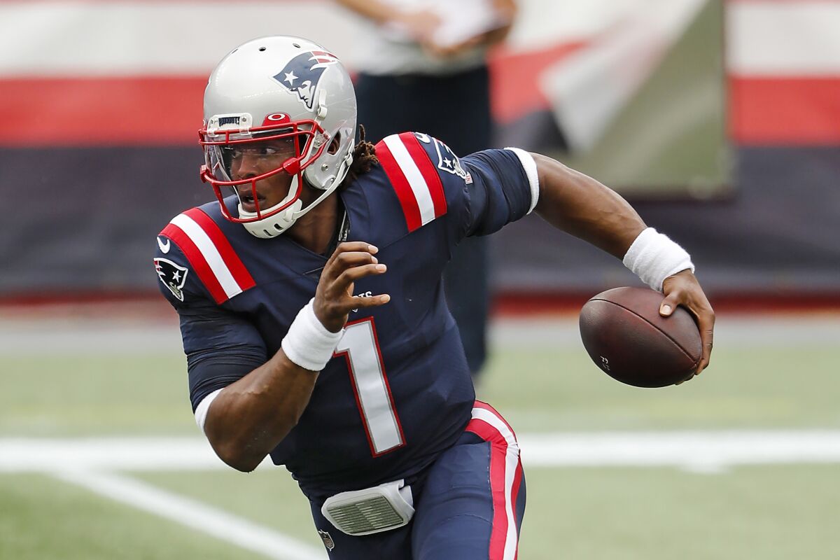 New England Patriots quarterback Cam Newton carries the ball against the Las Vegas Raiders.