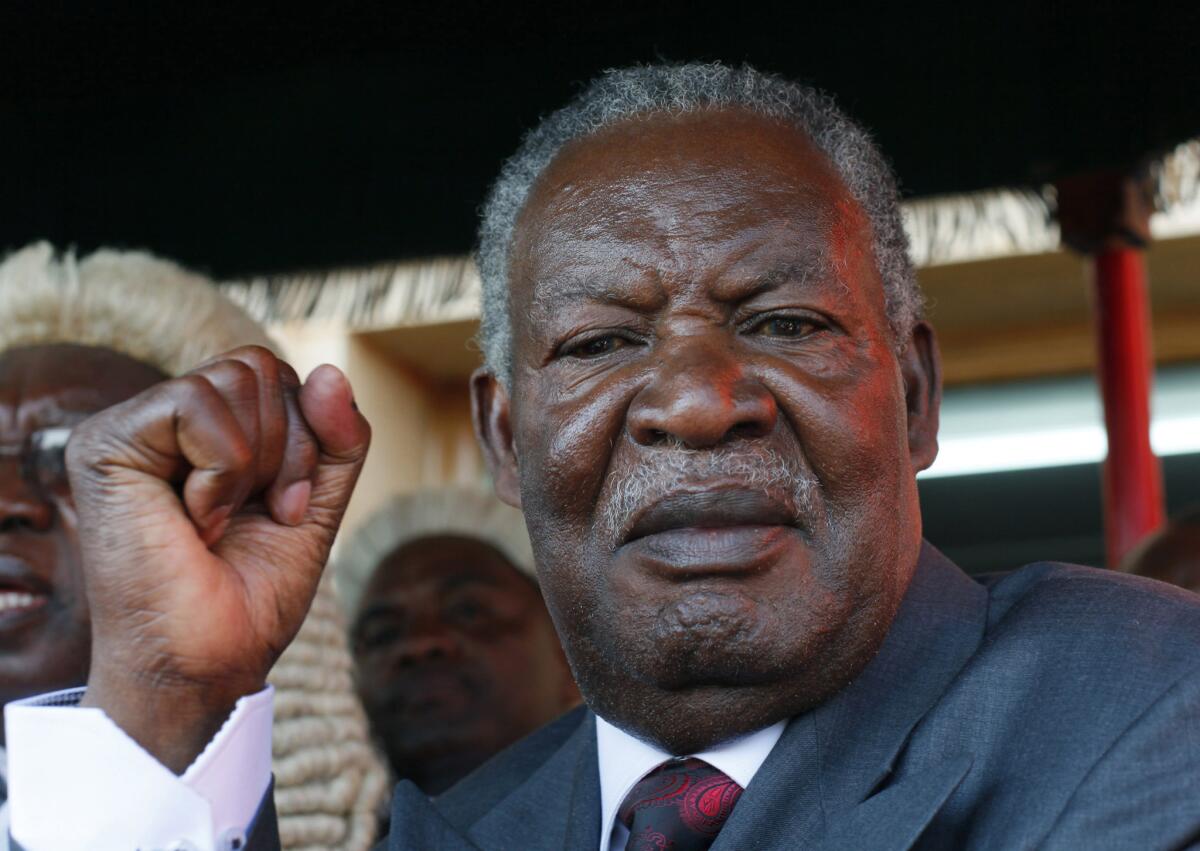 Zambian President Michael Sata waves after taking the oath of office in Lusaka on Sept. 23, 2011.