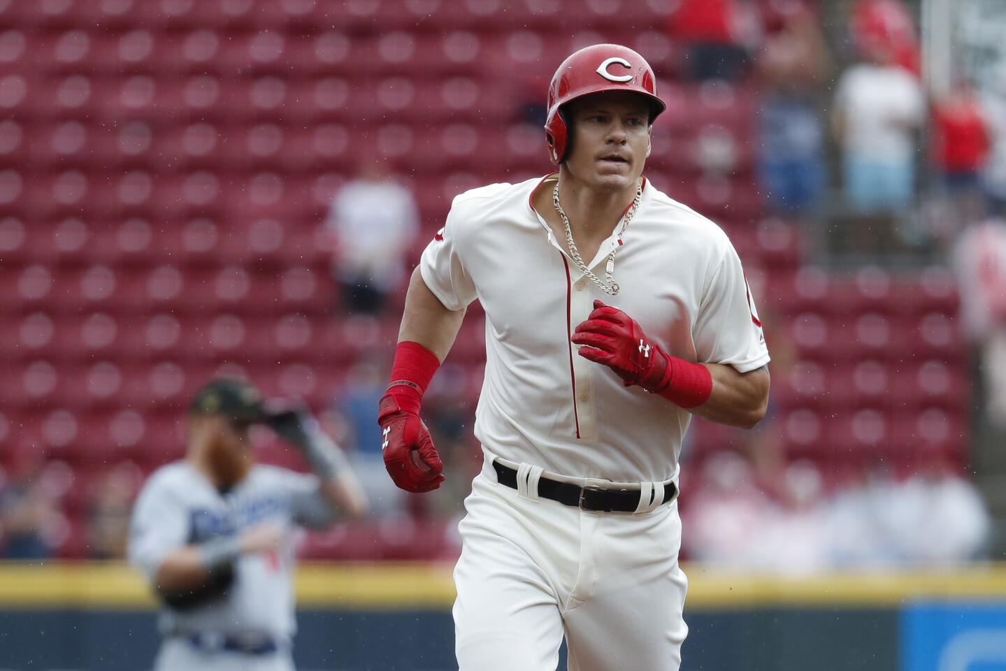 Cincinnati Reds' Derek Dietrich runs the bases after hitting a solo home run off Los Angeles Dodgers relief pitcher Yimi Garcia in the ninth inning of a baseball game, Sunday, May 19, 2019, in Cincinnati. (AP Photo/John Minchillo)