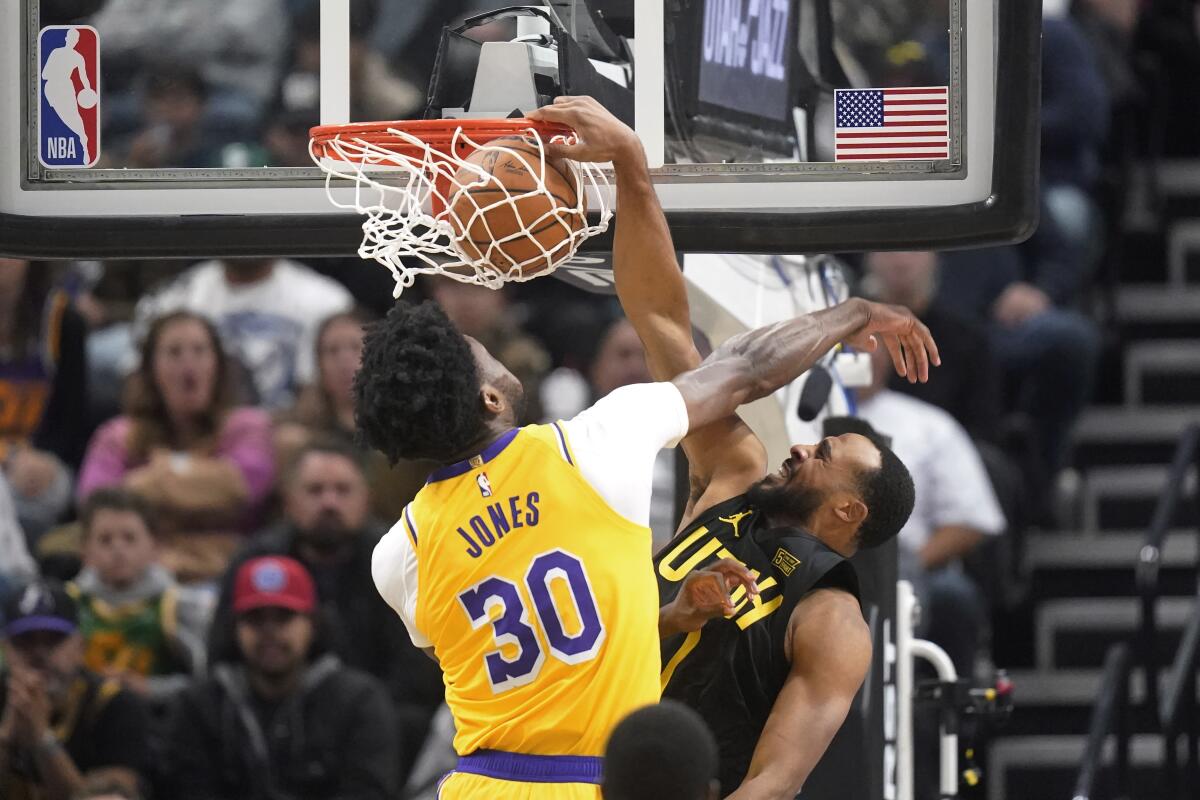 Utah Jazz guard Talen Horton-Tucker dunks against Damian Jones.
