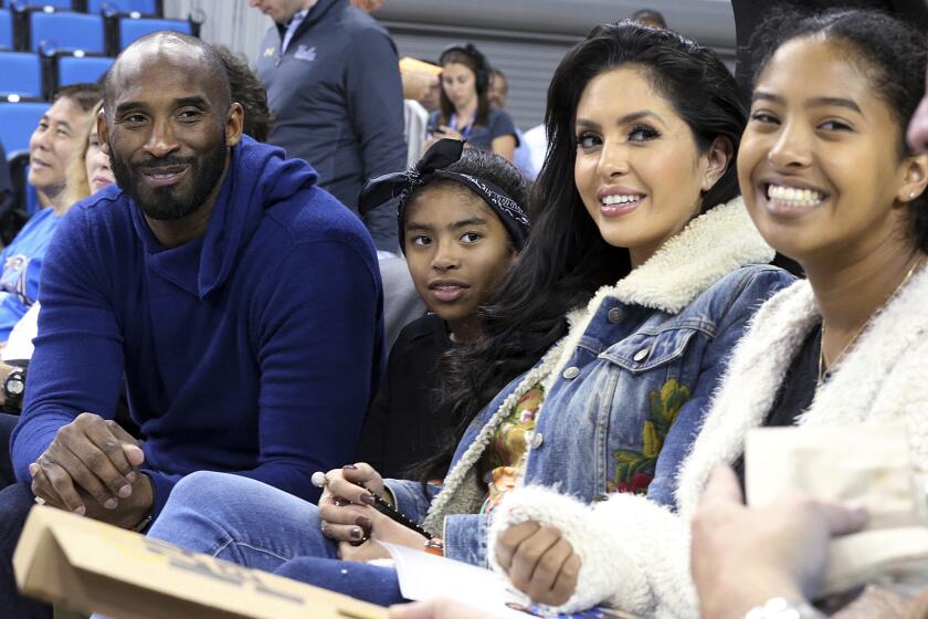 From left, Los Angeles Lakers legend Kobe Bryant, his daughter Gianna Maria-Onore Bryant, wife Vanessa and daughter Natalia Diamante Bryant are seen before a Connecticut-UCLA NCAA women's basketball game in Los Angeles Tuesday, Nov. 21, 2017. (AP Photo/Reed Saxon)
