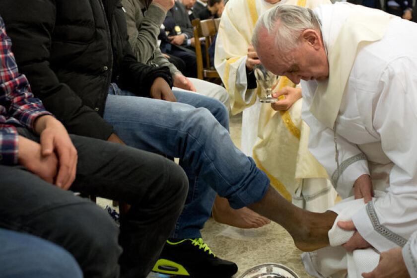 Pope Francis washes the foot of an inmate at the juvenile detention center of Casal del Marmo in Rome.