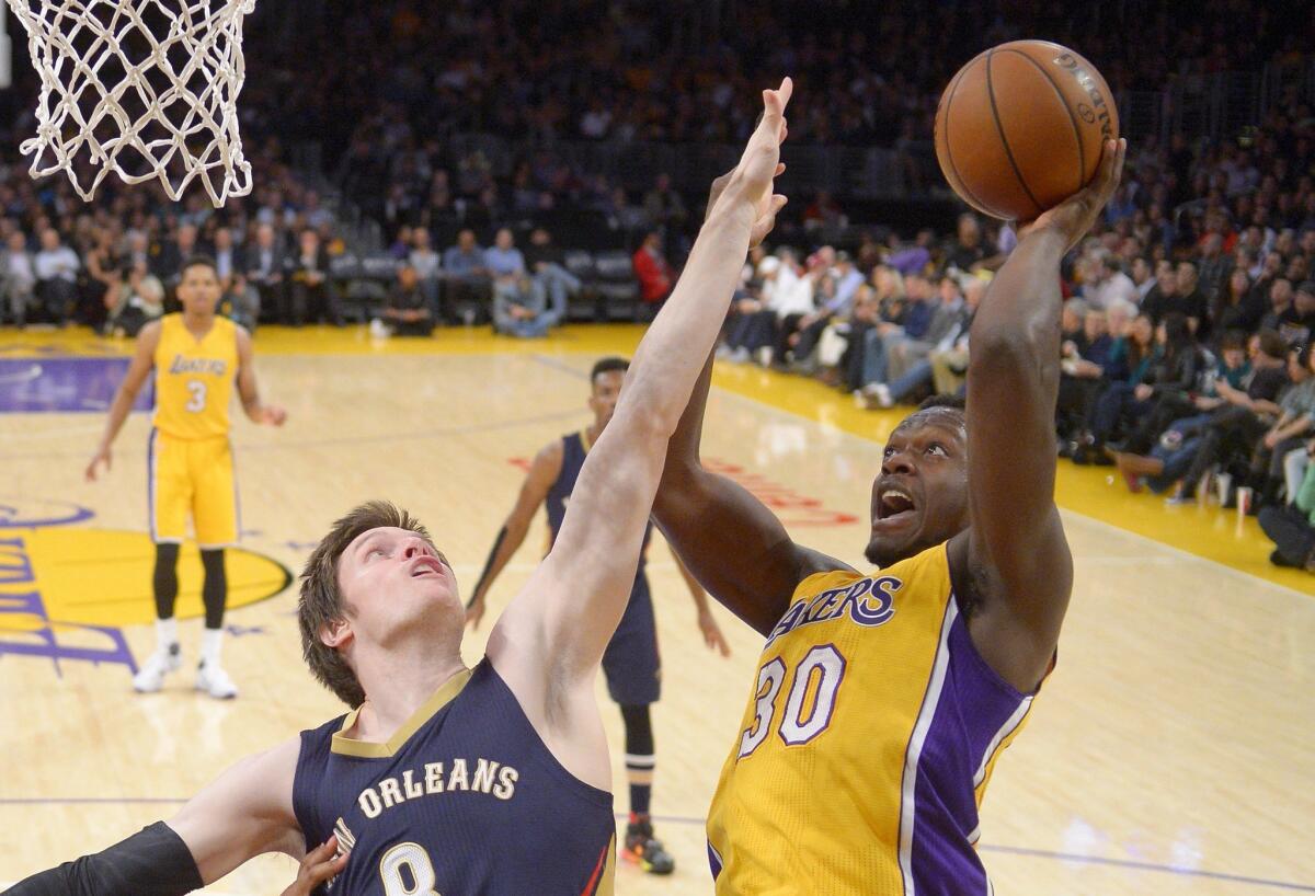 Lakers forward Julius Randle, right, shoots against New Orleans forward Luke Babbitt on Tuesday night.