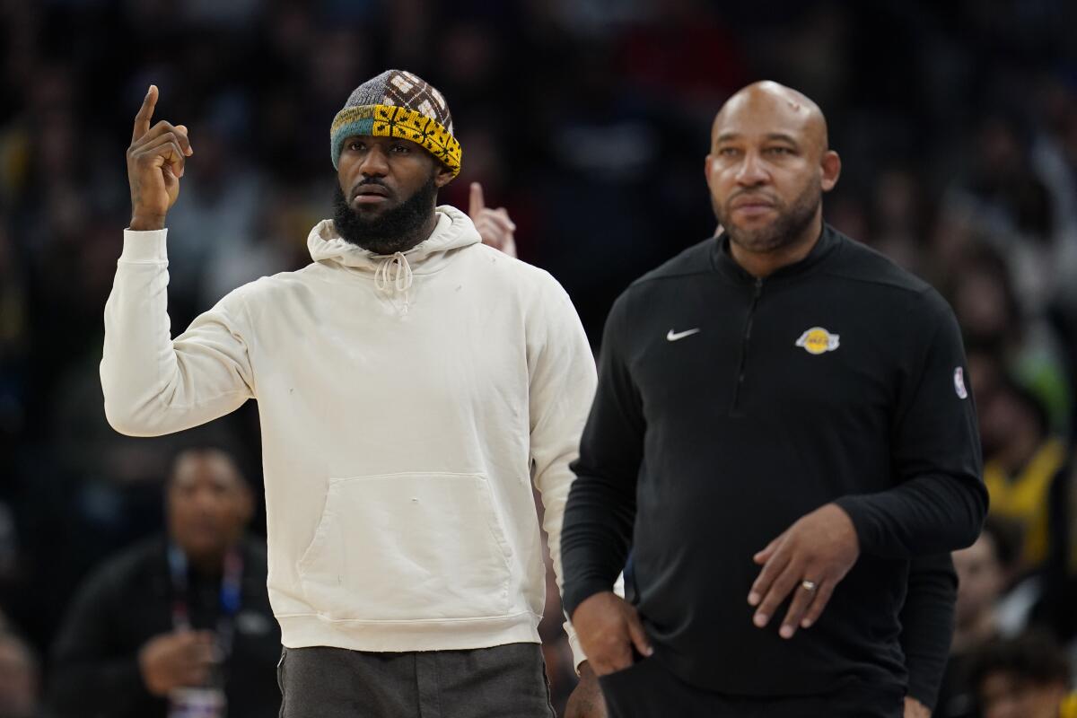 Lakers star LeBron James, left, gestures for a video review while standing next to coach Darvin Ham.