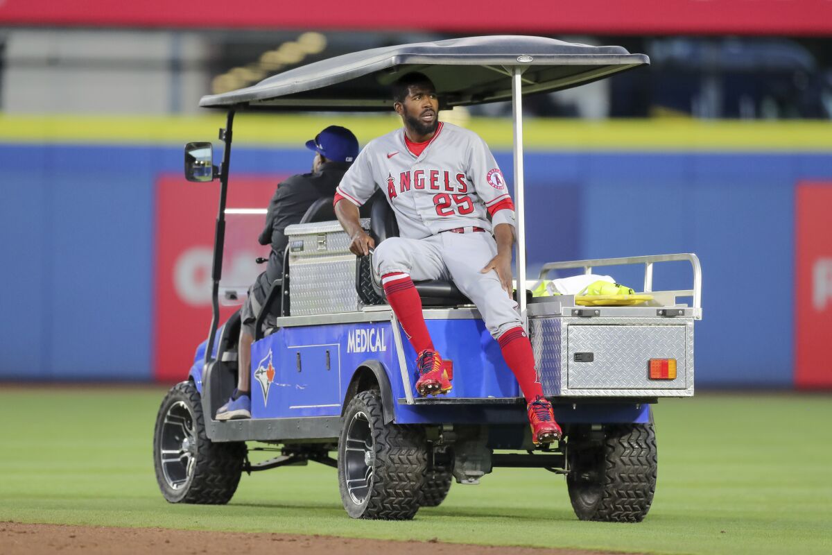 The Angels' Dexter Fowler is carted off after a play at second base against the Toronto Blue Jays.