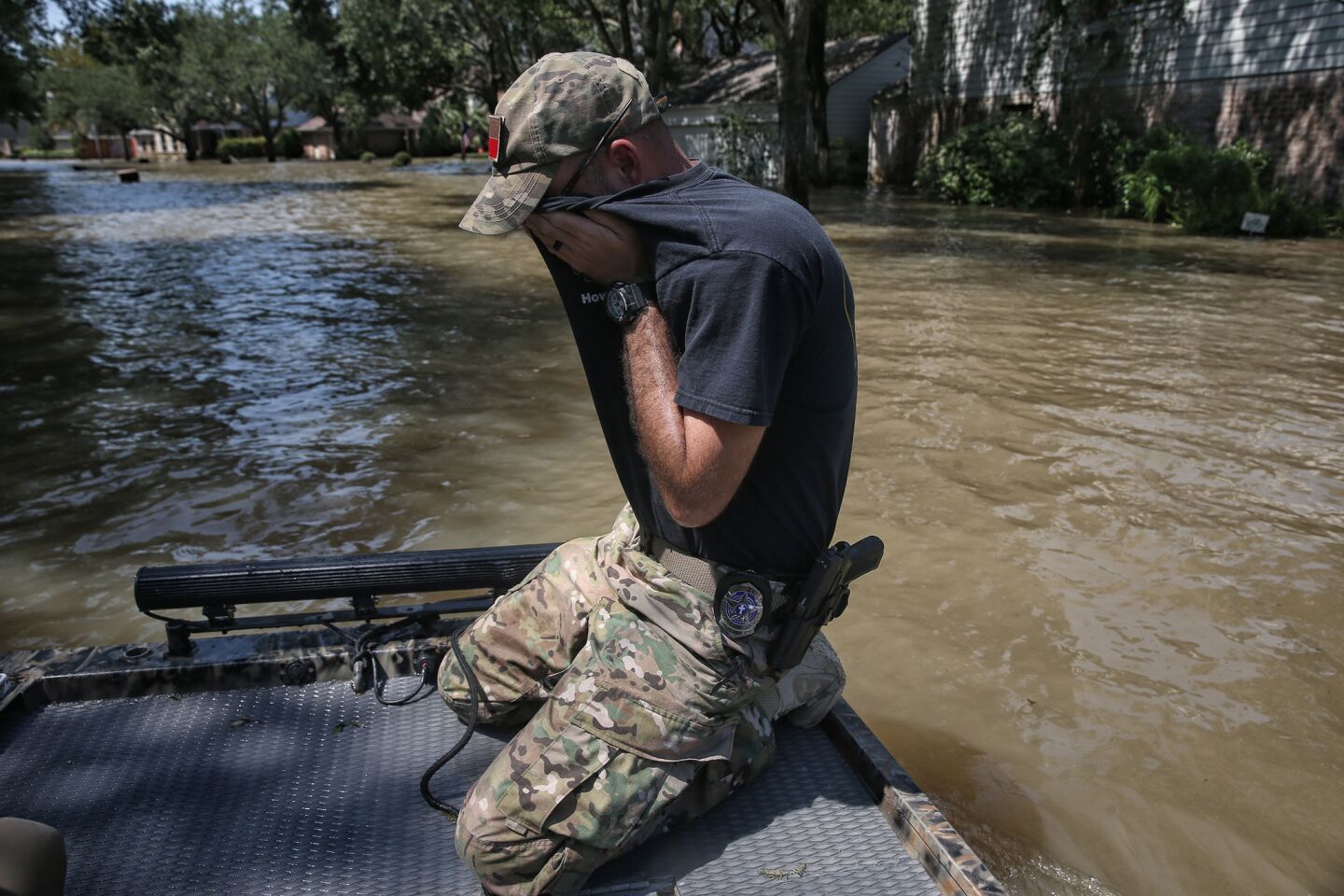 Wes Higgins wipes sweat from his face after spending five days patrolling flooded Houston neighborhoods in his boat. Higgins, from Knott, Texas, organized a volunteer team of 10 boats to help Houston residents.