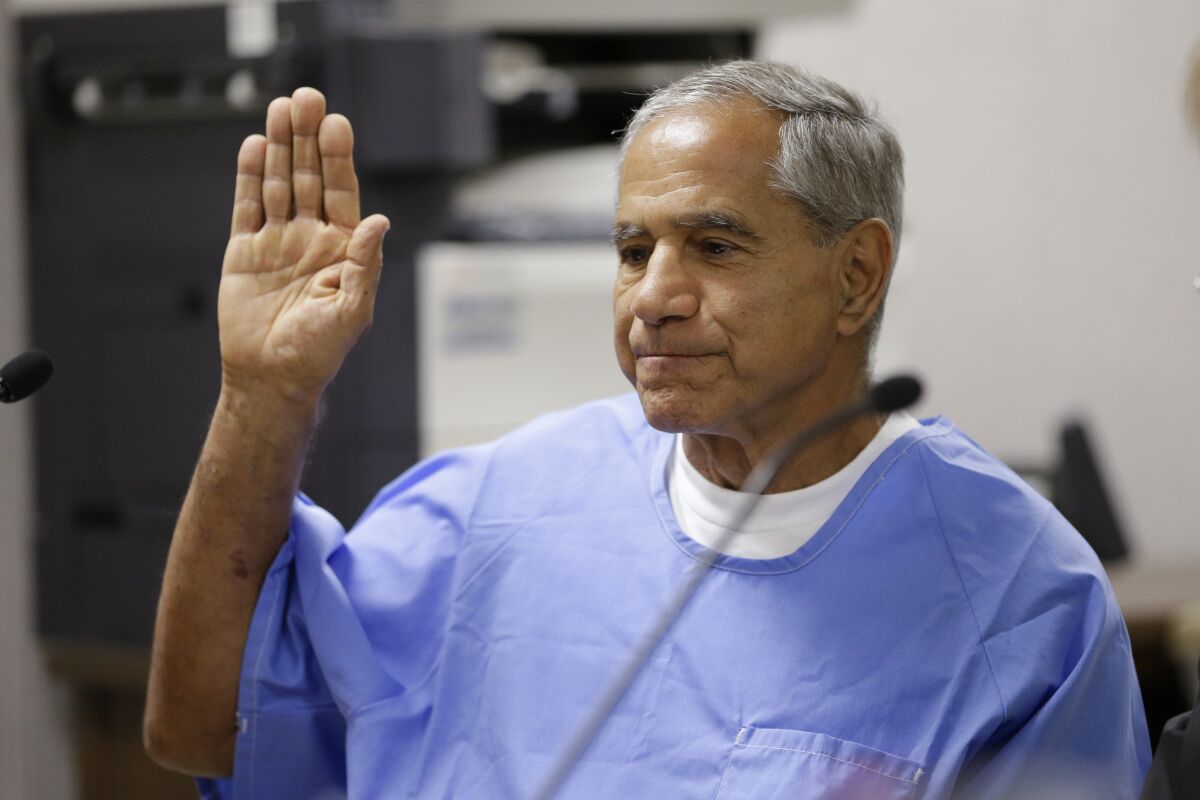 Sirhan Sirhan raises his right hand as he is sworn in during a parole hearing