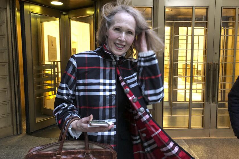 Columnist E. Jean Carroll leaves federal court Tuesday Feb. 22, 2022, in New York. Carroll, who accused former President Donald Trump of raping her in the mid-1990s and then filed a defamation lawsuit against him, will not seek to depose him prior to trial because it would cause unnecessary delay, but she added that a DNA sample was still being sought. (AP Photo/Larry Neumeister)