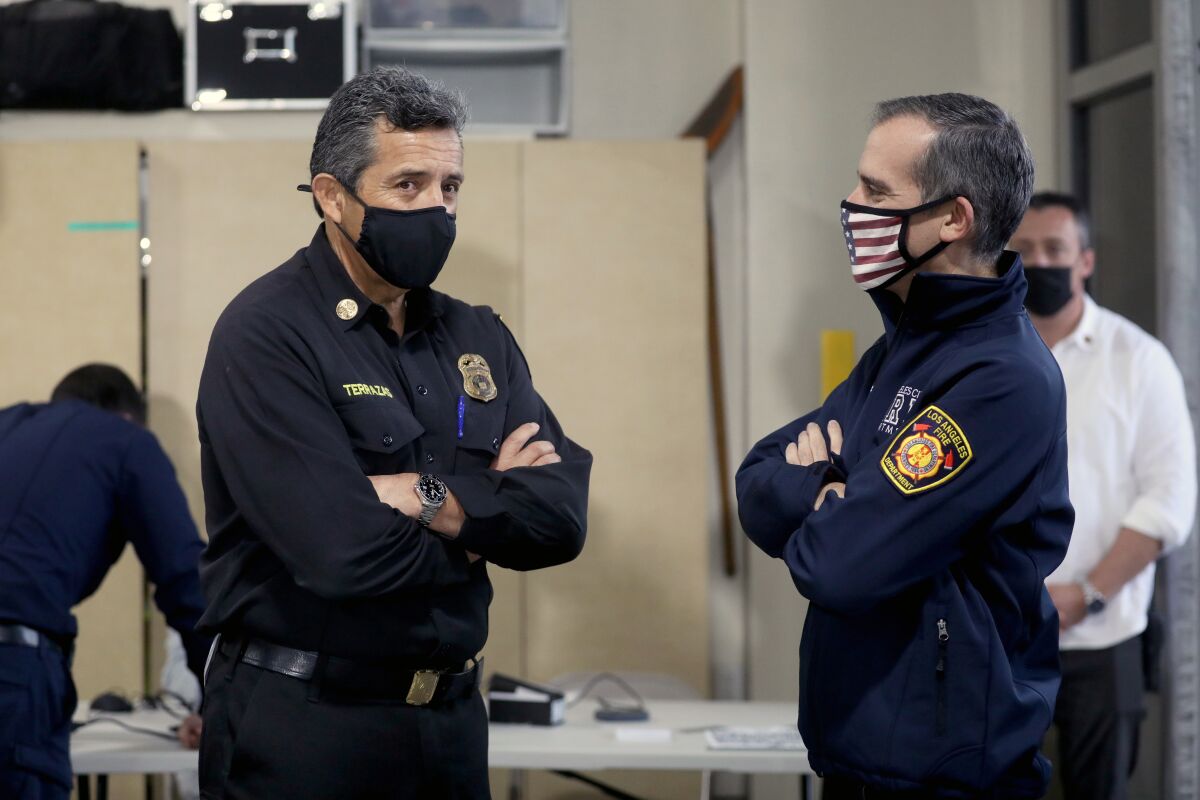 Los Angeles Fire Chief Ralph Terrazas, left, with Mayor Eric Garcetti at an LAFD vaccination program in December 2020.