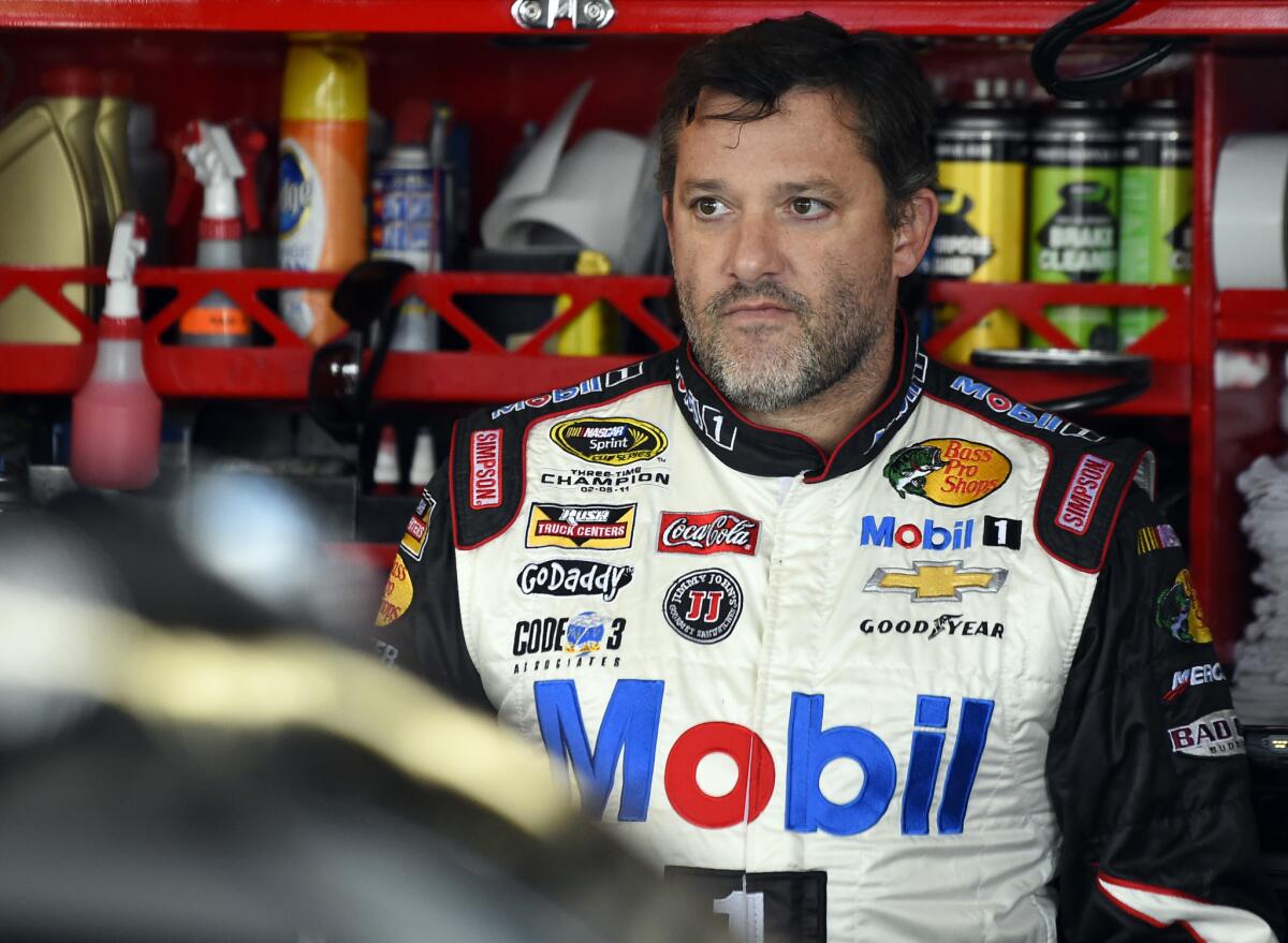 NASCAR driver Tony Stewart looks out from his garage during a practice for the Sprint Cup Series race at Chicagoland Speedway on Sept. 13.