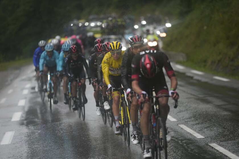 Tadej Pogacar, wearing the overall leader's yellow jersey, rides during the ninth stage of the Tour de France.