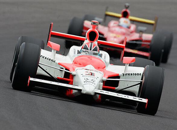 Pole-sitter Helio Castroneves of Brazil leads the field into the first turn during the 93rd running of the Indianapolis 500 at the Indianapolis Motor Speedway.