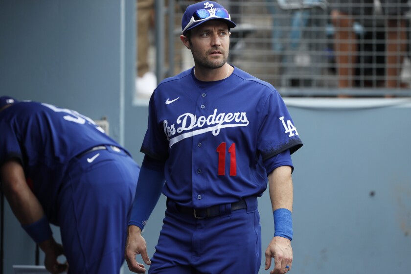 Los Angeles Dodgers' AJ Pollock looks over from the dugout while wearing a new Los Dodgers uniform.