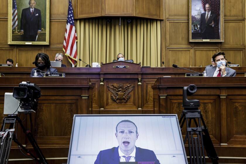 A video screen set up in a hearing room shows Facebook CEO Mark Zuckerberg testifying in July before a House subcommittee