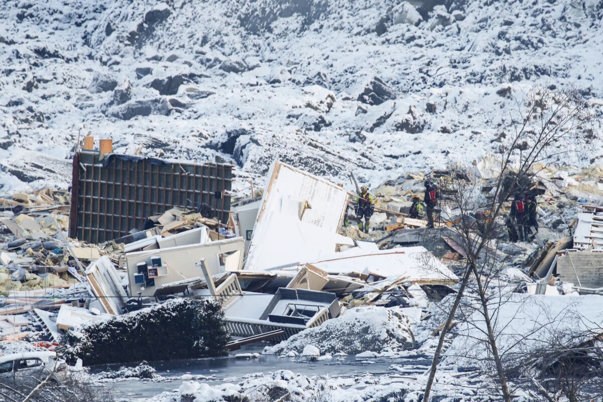 Rescue work continues after the large landslide that destroyed several houses at Ask in Norway, Tuesday, Dec. Jan 5, 2021. Several homes were taken by the landslide early Wednesday Dec. 30, killing seven people, while three are still reported missing. (Terje Pedersen / NTB via AP)