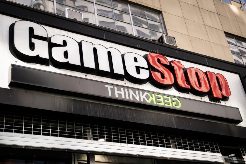 FILE - Pedestrians pass a GameStop store on 14th Street at Union Square, Thursday, Jan. 28, 2021, in the Manhattan borough of New York. Shares of GameStop are soaring before the market opened on Monday, June 3, 2024 following speculation that the man at the center of the pandemic meme stock craze owns a large number of shares of the video game retailer that may be worth millions.. (AP Photo/John Minchillo, File)