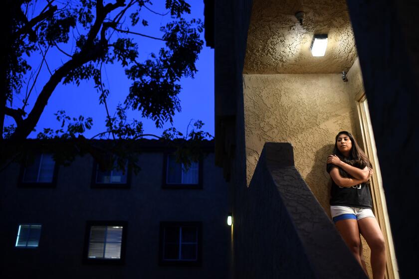 PICO RIVERA, CALIFORNIA MARCH 17, 2020-Melanie Santos stands outside her apartment in Pico Rivera was recently laid off as a substitute teacher. (Wally Skalij/Los Angeles Times)