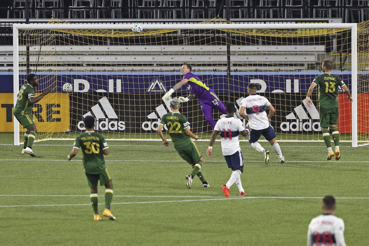 Portland Timbers goalkeeper Steve Clark makes a save against the Vancouver Whitecaps during an MLS soccer match, Sunday, Sept. 27, 2020, in Portland, Ore. (Sean Meagher/The Oregonian via AP)