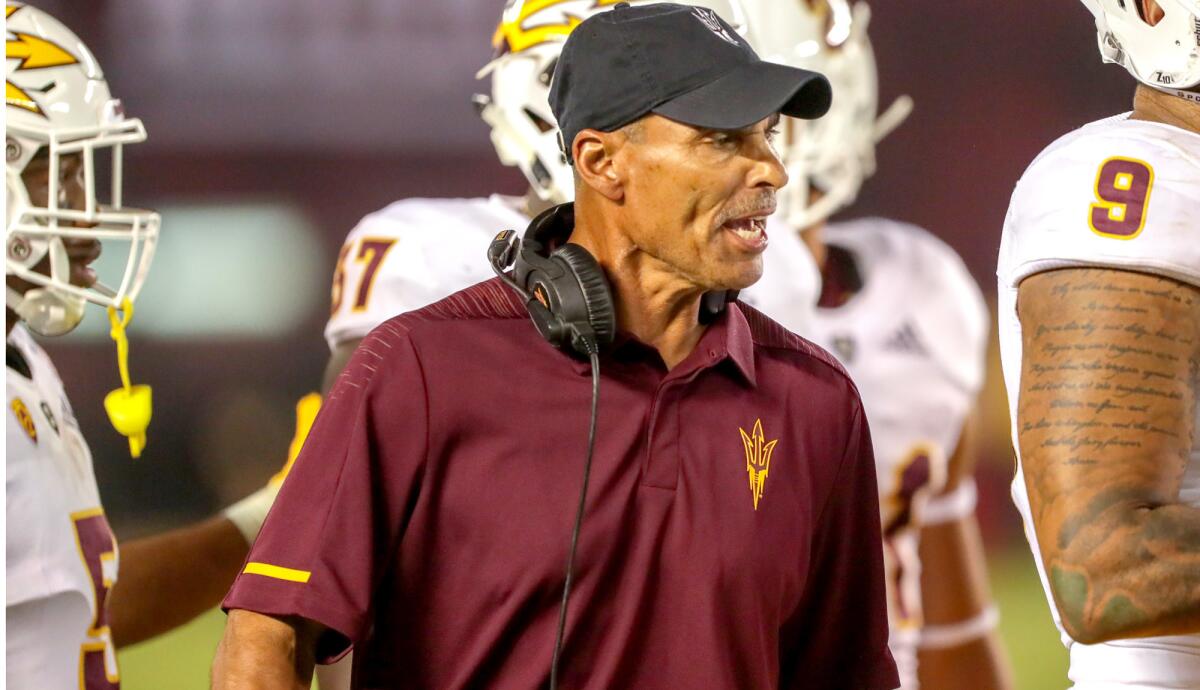 Coach Herm Edwards prepares to talk to his Arizona State players during a timeout in a game against San Diego State on Sept. 15.