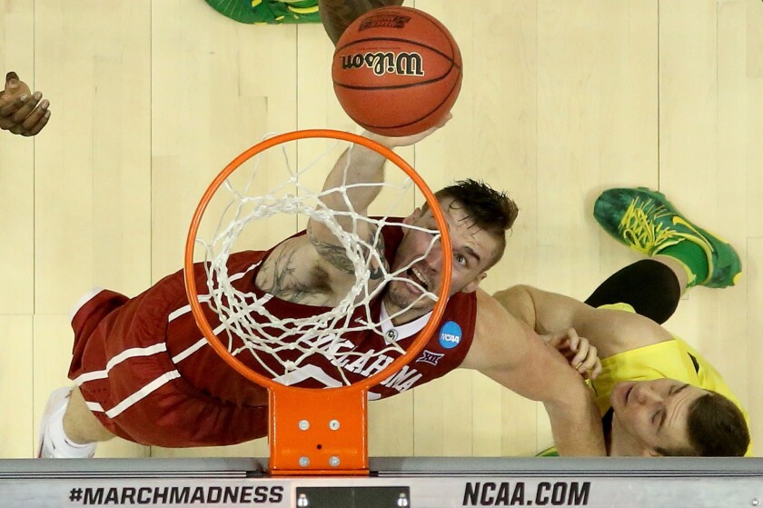 Oklahoma forward Ryan Spangler goes up for the ball against Oregon forward Casey Benson during the second half of a game on March 26.