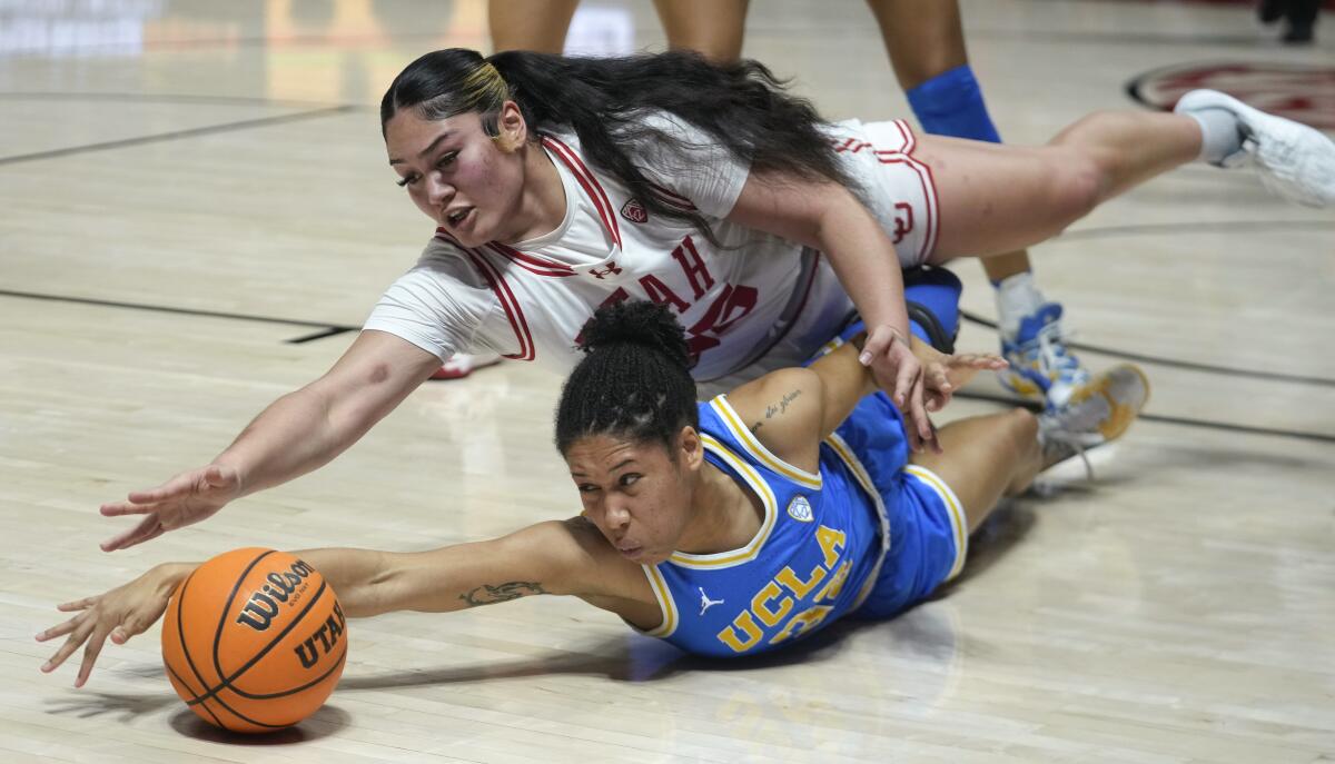 Utah's Alissa Pili, left, and UCLA guard Camryn Brown, right, battle for a loose ball.