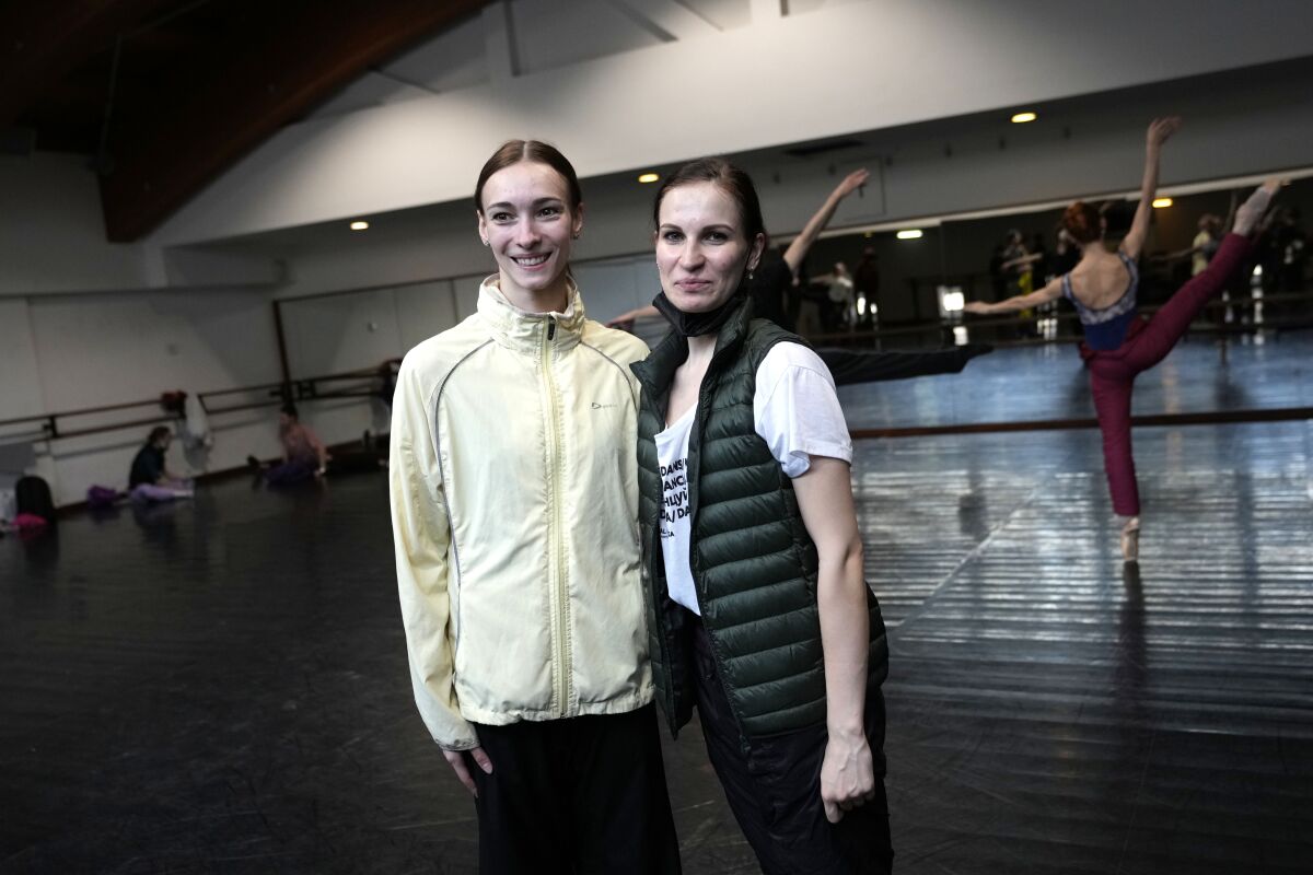 Olga Smirnova, left, and Anastasya Gurskaya, pose for a photograph in Naples, Monday, April 4, 2022. Gurskaya, a top ballerina in Kyiv's Opera, who fled the fighting in Ukraine and prima ballerina Olga Smirnova, who quit the Bolshoi last month over the Russian invasion rehearsed on a stage in Naples ahead of a sold-out benefit performance Monday night to raise funds for the Red Cross and champion the cause of peace. (AP Photo/Alessandra Tarantino)