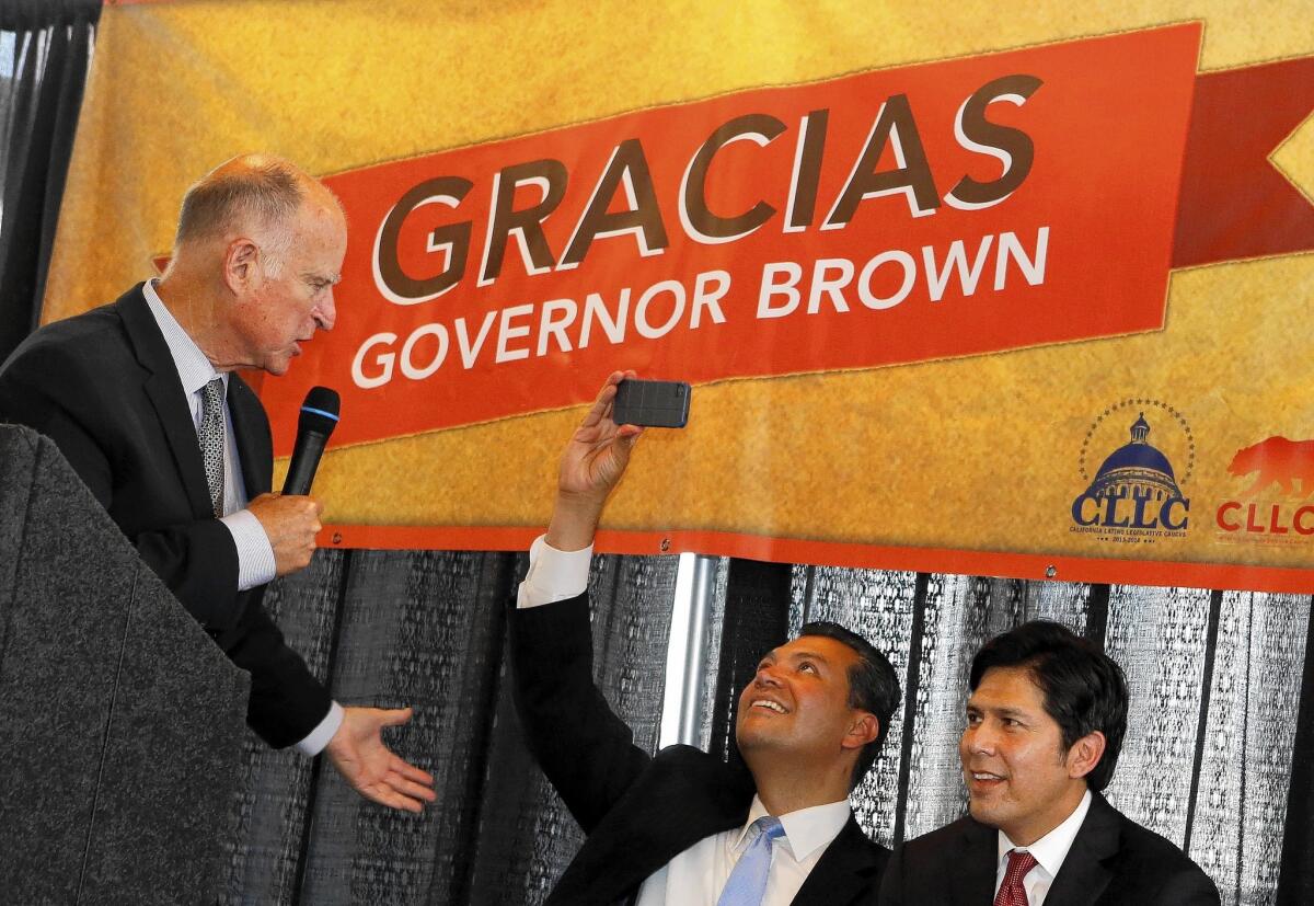 Gov. Jerry Brown, left, acknowledges state Sens. Alex Padilla, center, and Kevin de León during his visit to El Pueblo de Los Angeles. Meanwhile, his GOP gubernatorial rival, Neel Kashkari, was guest-hosting the "Ken and John Show" radio program.