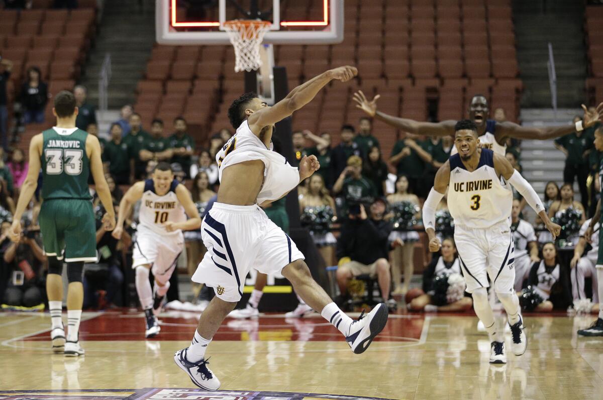 UC Irvine's Aaron Wright, center, celebrates the team's 67-58 win over Hawaii in the Big West tournament championship game on Saturday night.