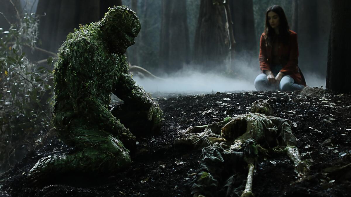Derek Mears and Crystal Reed in "Swamp Thing" on The CW.
