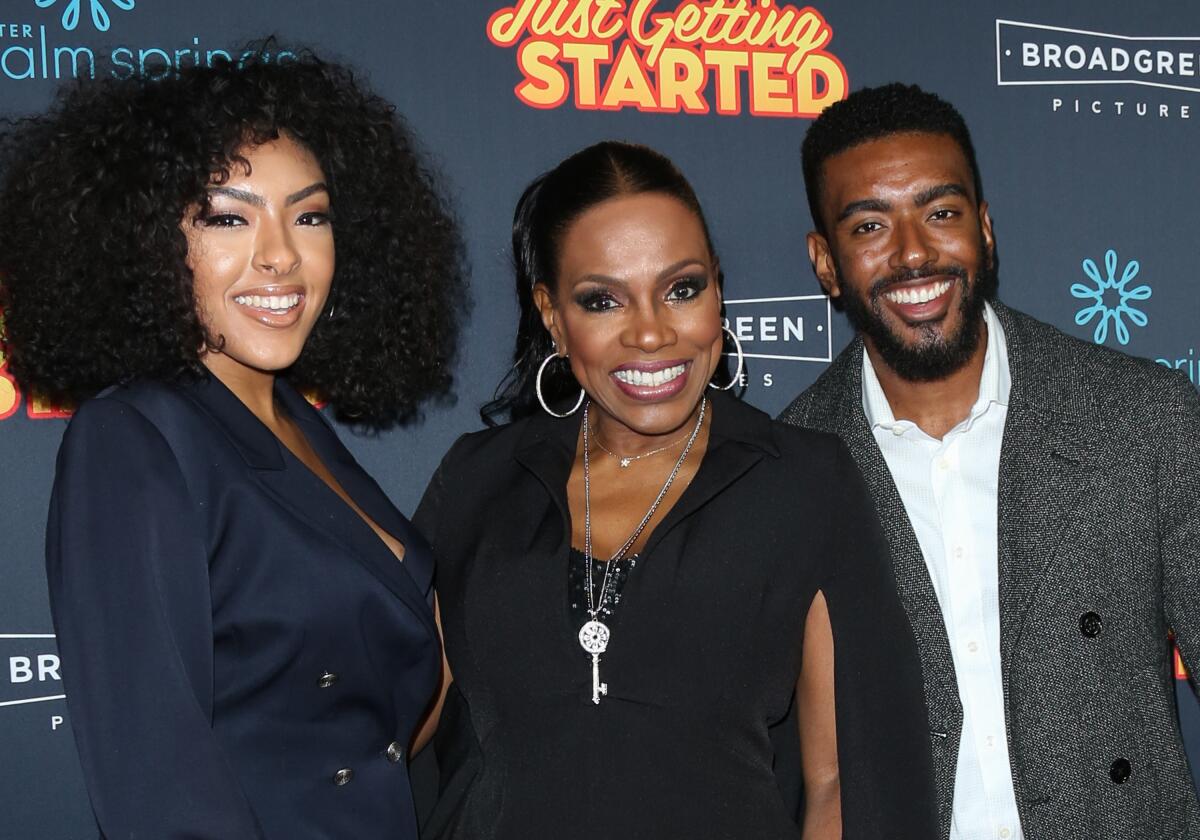 Sheryl Lee Ralph smiles between adult children Ivy-Victoria Maurice, left, and Etienne Maurice.