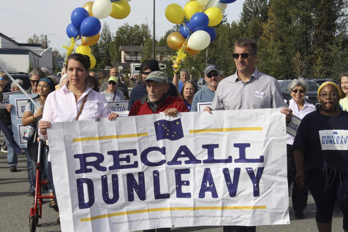 FILE - In this Sept. 5, 2019, file photo, Meda DeWitt, left, Vic Fischer, middle, and Aaron Welterlen, leaders of an effort to recall Alaska Gov. Mike Dunleavy, lead about 50 volunteers in a march to the Alaska Division of Elections office in Anchorage, Alaska. The group opposed to Dunleavy has yet to gather enough signatures to force a recall election, nearly two years after launching and with just over a year before the 2022 primary election. (AP Photo/Mark Thiessen, File)